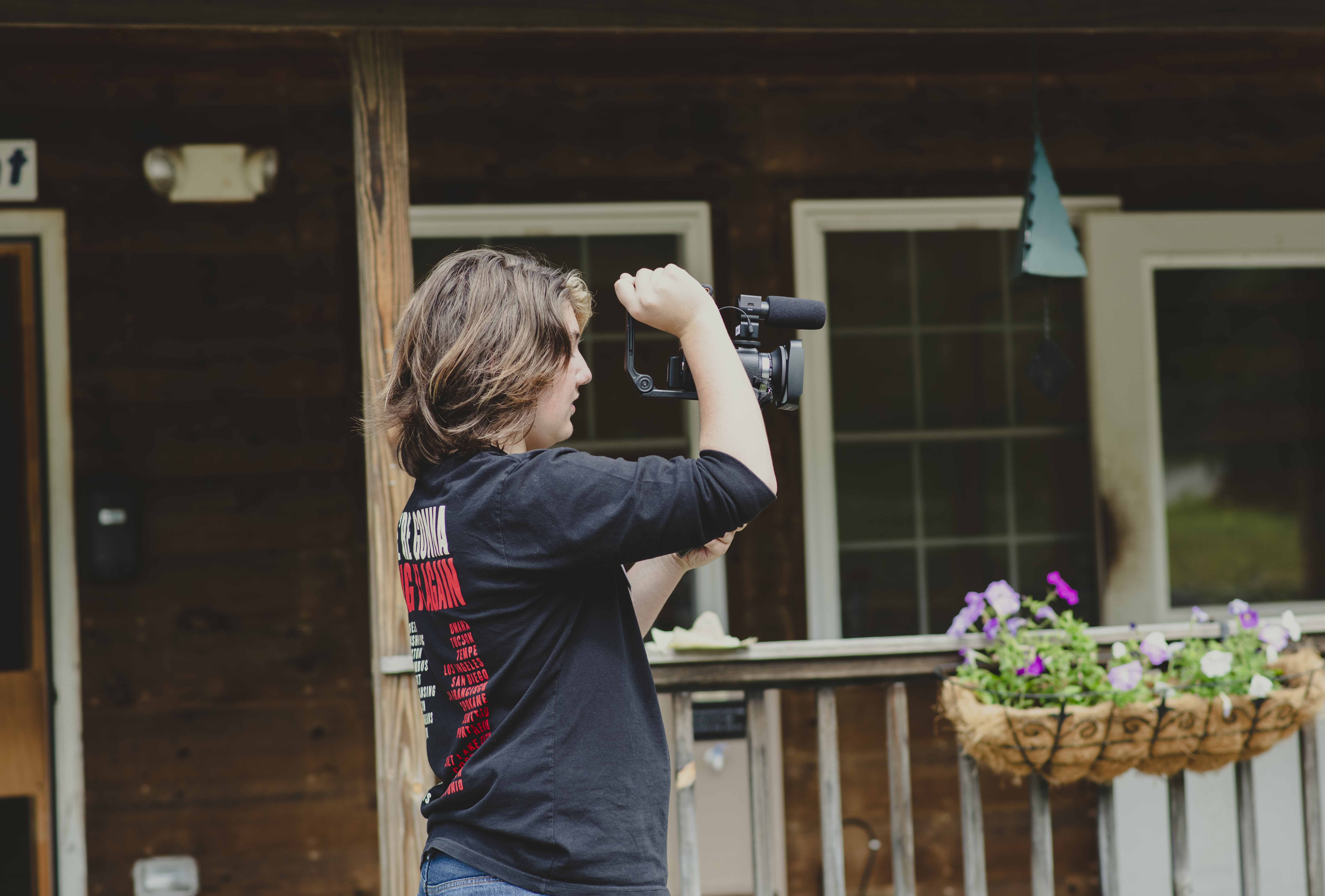 Staff Member Filming Camp Performance